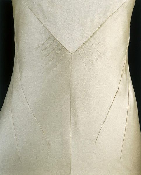 the back of a white wedding dress on display