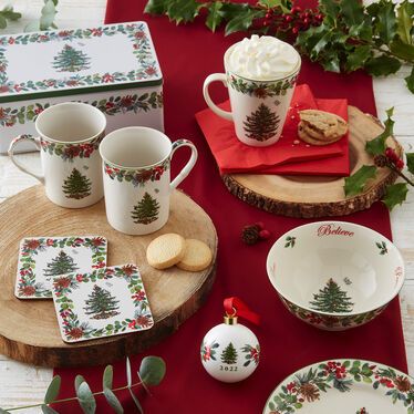 a table topped with christmas themed dishes and cups