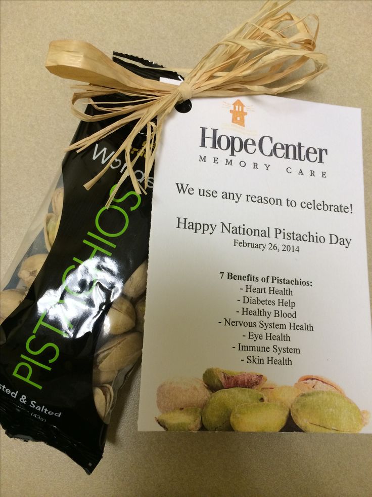 a bag of pistachios next to a sign that says happy national pistachio day