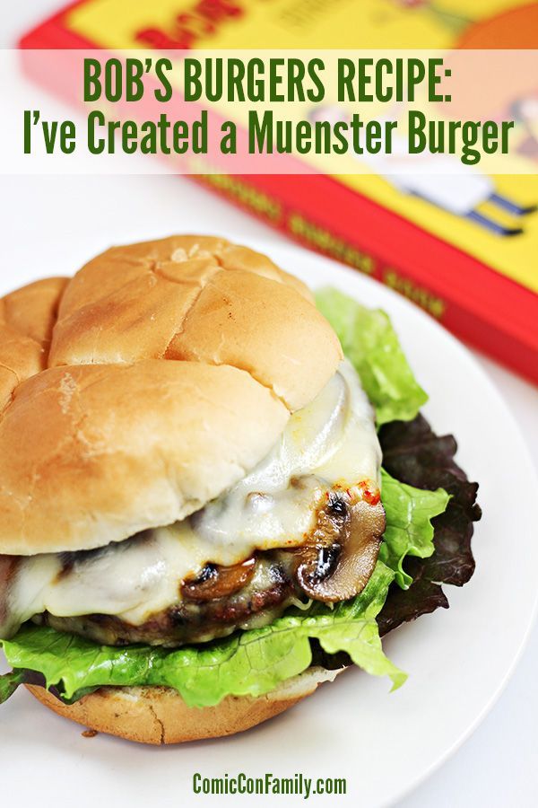 a burger with lettuce, mushrooms and cheese is on a plate next to a children's book