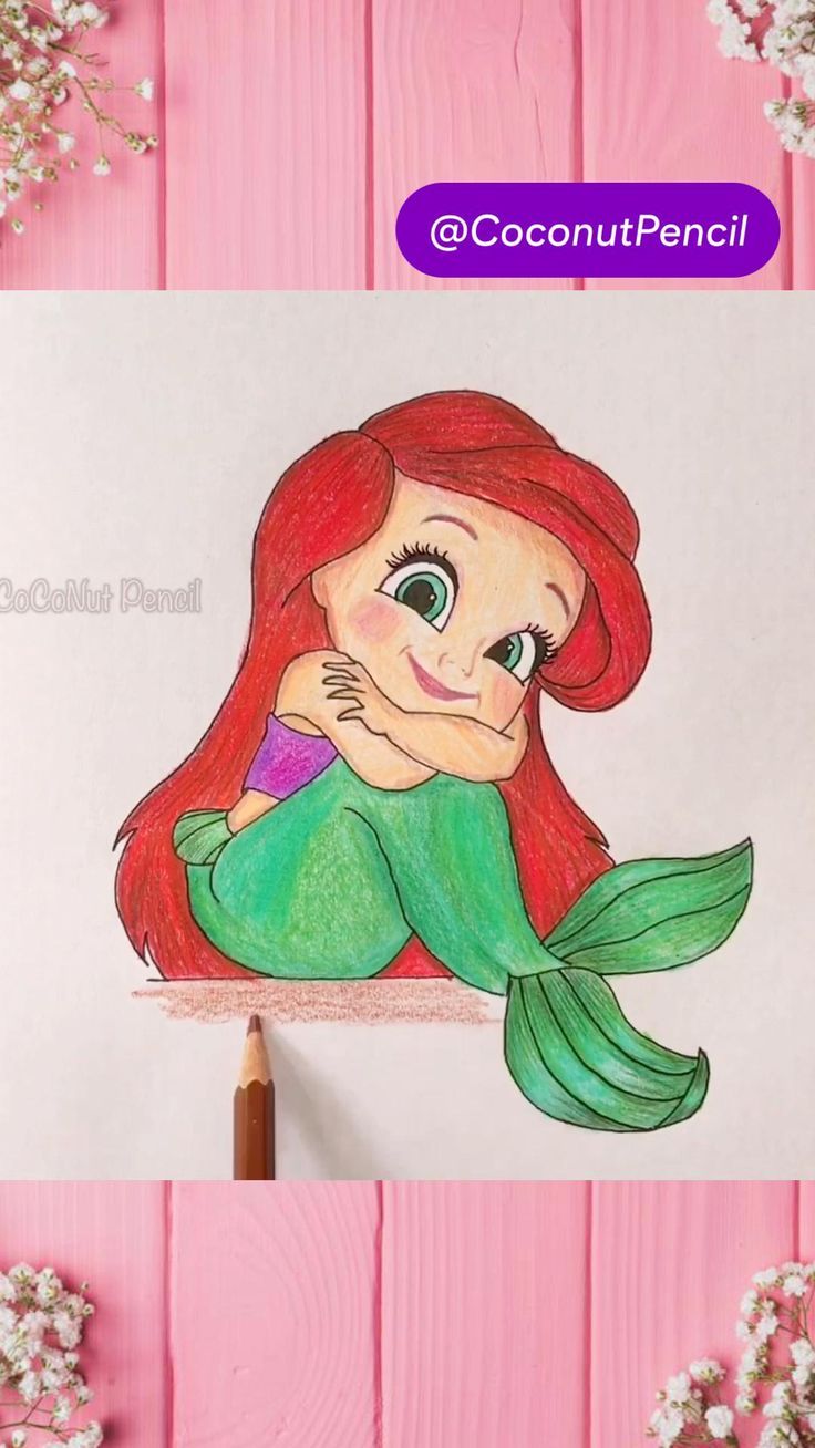 the little mermaid is sitting on top of a piece of paper