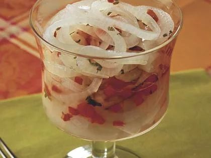 an onion salad in a glass on a table