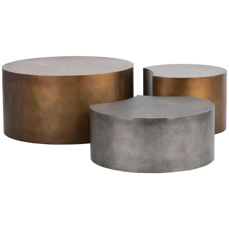 two round metal tables sitting next to each other