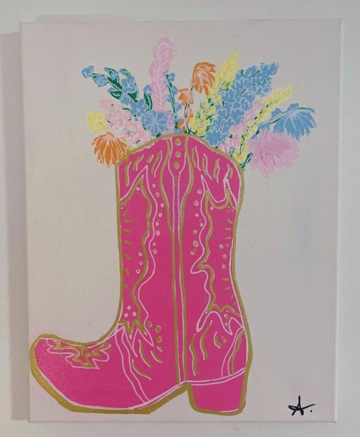 a pink cowboy boot with flowers in it