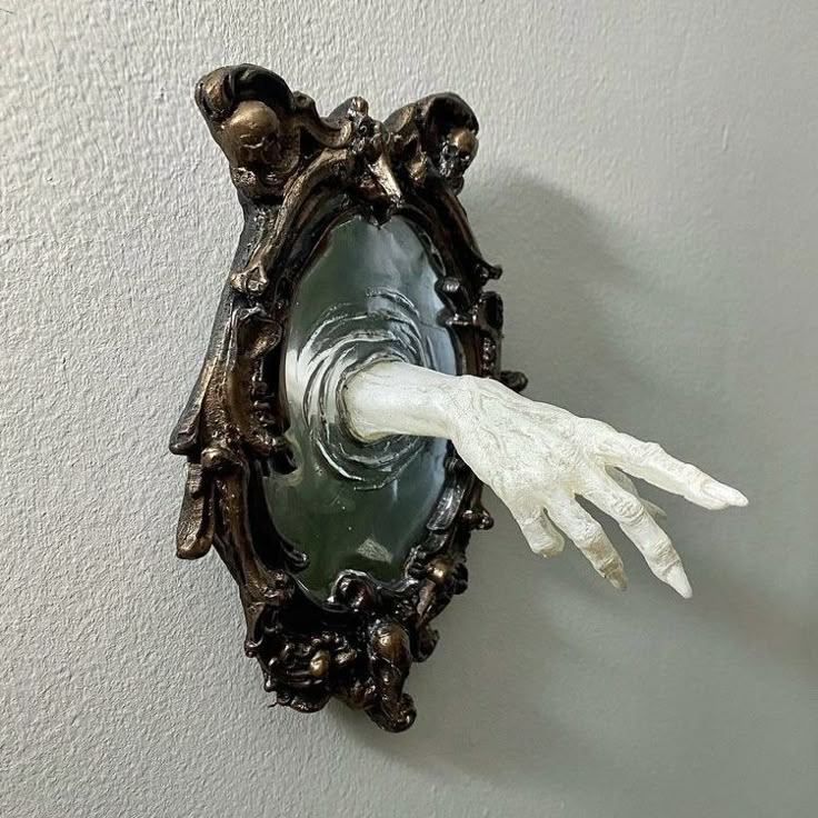 a white glove hanging from the side of a wall mounted light fixture in a room