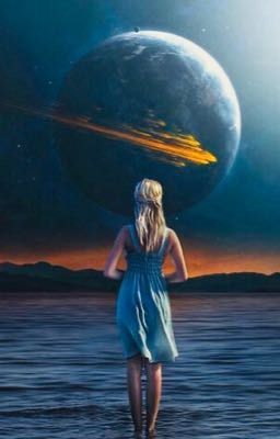 a woman standing in the water looking at an object floating in the sky above her