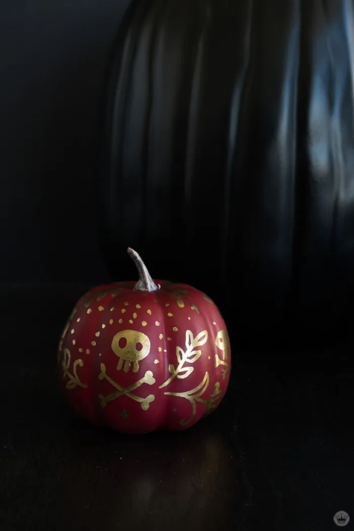 a painted pumpkin sitting on top of a table