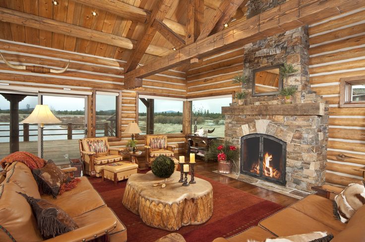 a living room filled with furniture and a fire place in the middle of a room