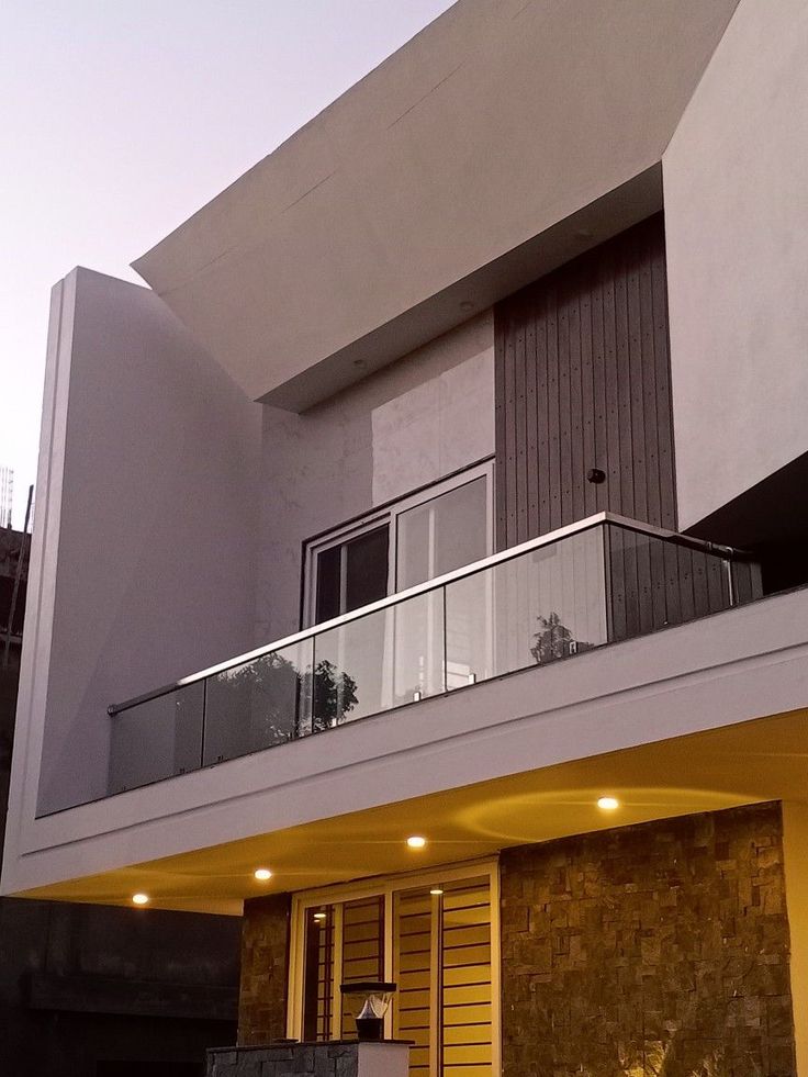 an apartment building with balconies and lights on the balcony