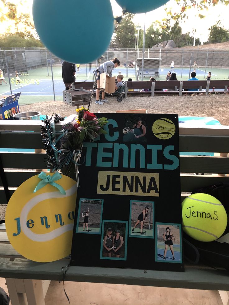 a tennis racket and ball are sitting on a bench in front of a sign