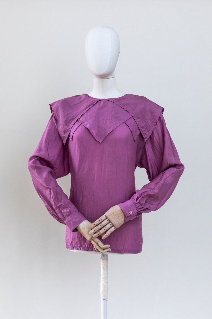 Vintage violet silk blouse with unique collar. Long sleeves, buttoned down on the back, shoulder pads, relaxed fit. Condition: good vintage condition, there are few tiny holes in the fabric in the lower part of the item. The item is freshly laundered and ready to wear. Fabric: 100% silk Label: no label Measurements:  Best Fit: M-L All measurements are taken lying flat and have already been doubled Shoulders: 48 cm / 19" Sleeves: 61 cm / 24" Chest: 118 cm / 38" Waist: 120 cm / 47" Length: 66cm / Purple Blouse, Silk Lace, Purple Top, Collar Blouse, 1980s Vintage, Blouse Vintage, Lace Blouse, Silk Blouse, Puff Sleeves