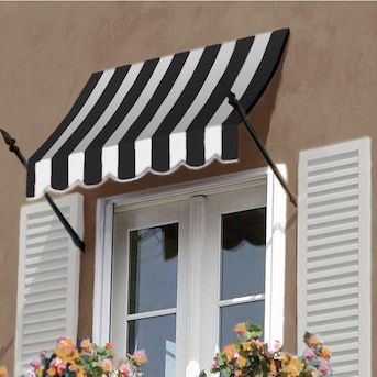 an awning on the side of a building with flowers in it