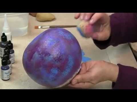 someone is painting an egg with purple paint