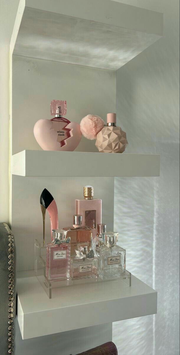 three shelves filled with different types of perfumes