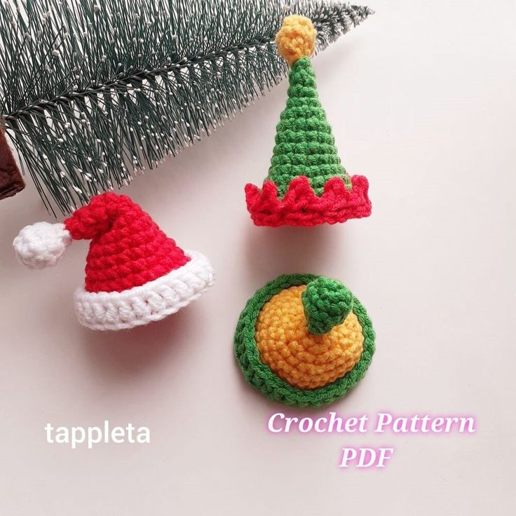 three crocheted christmas ornaments are shown next to a pine cone ornament