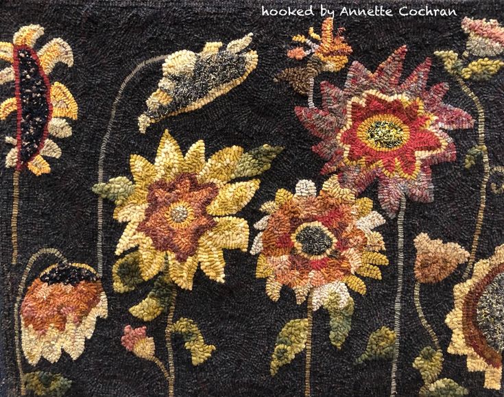 a close up of a rug with flowers on it