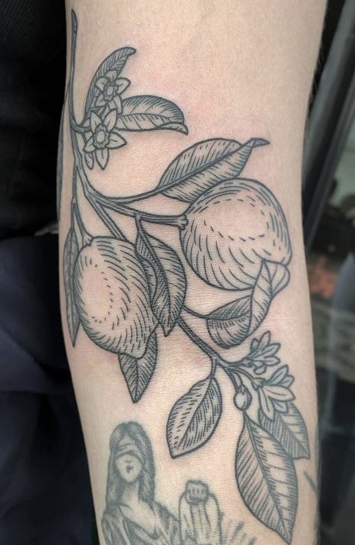 a tattoo on the arm of a woman with fruit