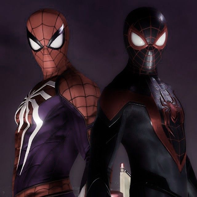 two spider - man standing next to each other