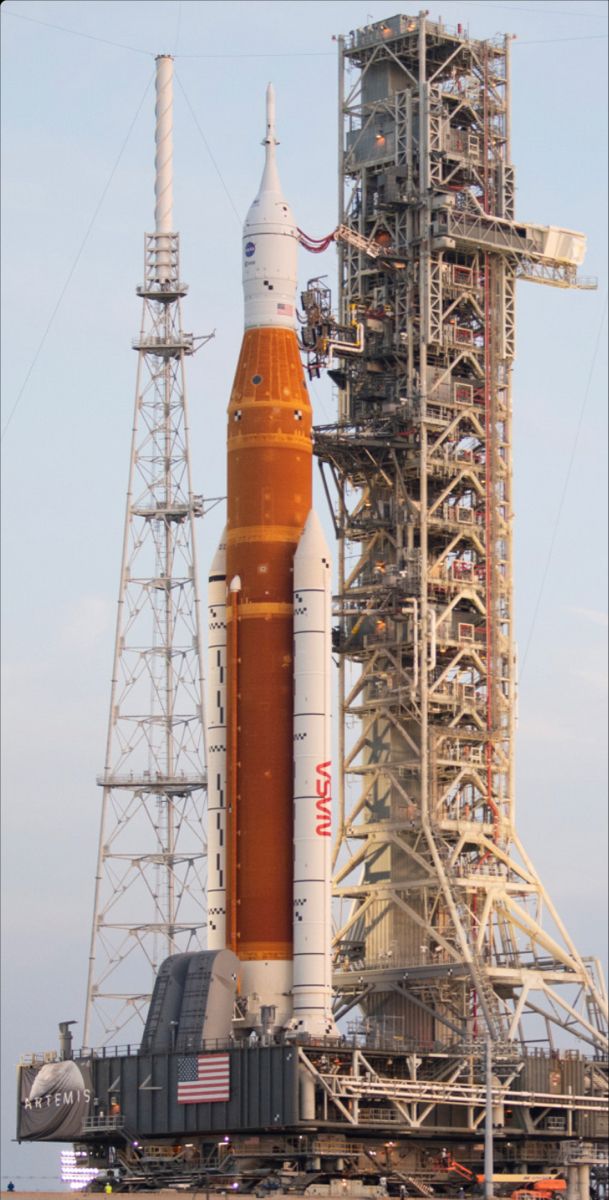 an orange and white rocket sitting on top of a building