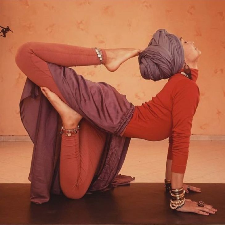 a woman is doing yoga on the floor