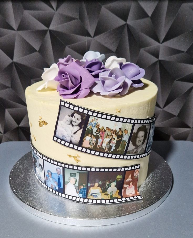 a cake decorated with film strips and flowers