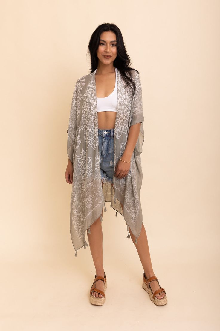 Update your vacation wardrobe with the stylish Mandala Tassel Kimono. This cute kimono will give you a cool, trendy look that's perfect for any beach destination or sunny getaway. Whether you pair it up with simple shorts or show off your feminine shape with a skirt, this kimono is sure to make you look and feel completely adorable. Showcasing beautiful colors and tassels, the Mandala Tassel Kimono is definitely the quintessential must-have item of the season! #lovemyleto 100% Viscose Imported Bohemian Lightweight Cover-up For Day Out, Lightweight Wrap Beach Cover-up, One Size Long Cover-up For Day Out, Vacation Beach Cover-up Kimono With Kimono Sleeves, Chic Summer Wrap Cover-up, Summer Beach Cover-up Kimono, Beachy Cover-up With Kimono Sleeves For Festivals, Summer Wrap Cover-up Free Size, Chic Beach Season Cover-up With Open Front