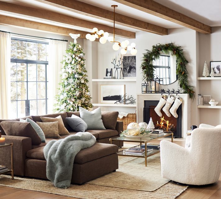 a living room filled with furniture and christmas decorations