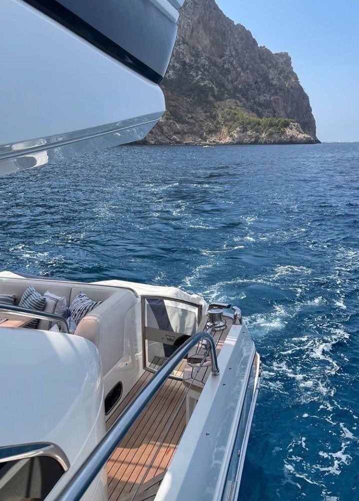 there is a small island in the middle of the water and a boat on it's side