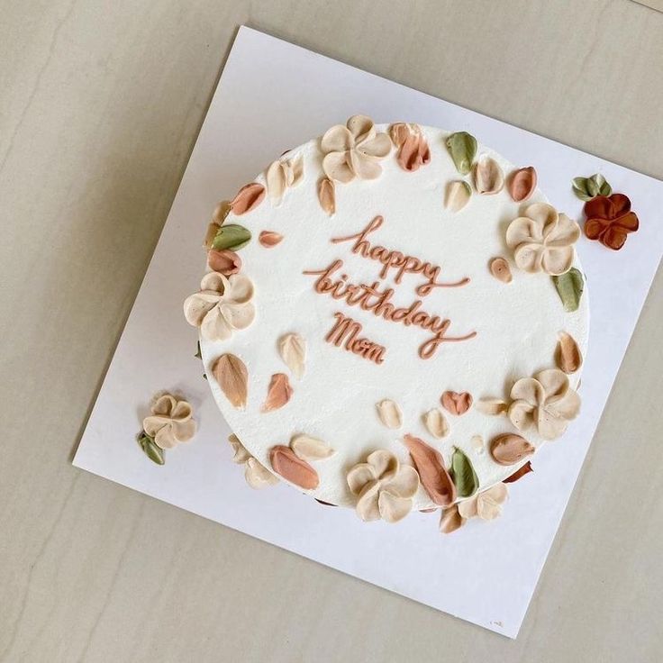 a birthday cake with nuts on it sitting on top of a card that says happy birthday mom