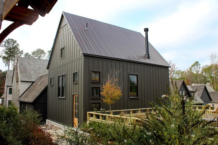 a house with a metal roof and wooden steps