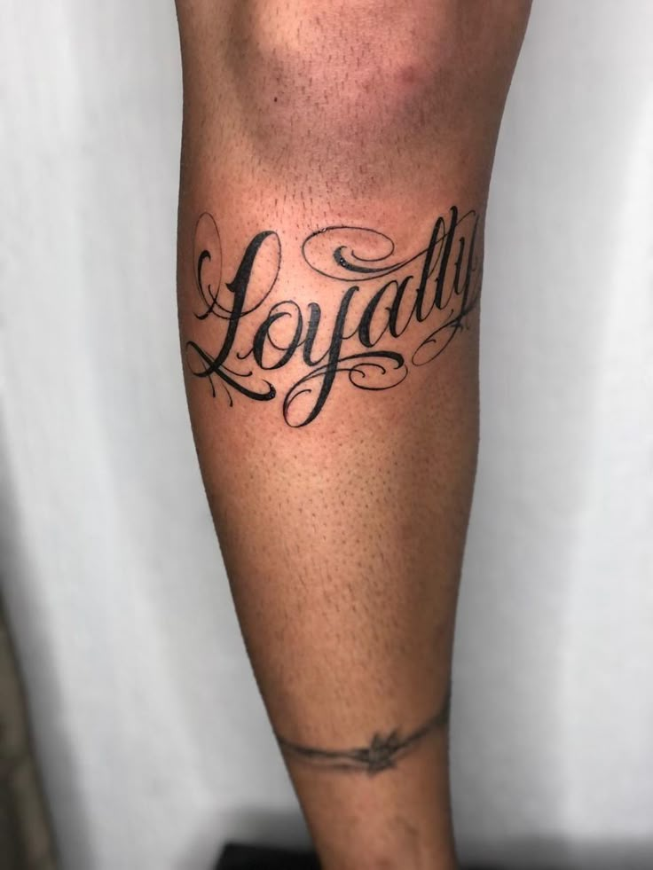 a man's leg with the word joy written in cursive writing