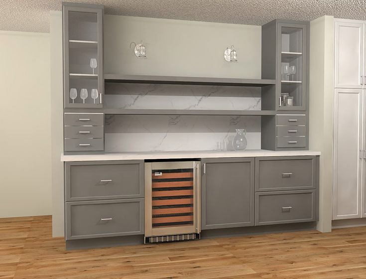 an empty kitchen with cabinets and wine glasses on the cabinet doors, in front of a wooden floor