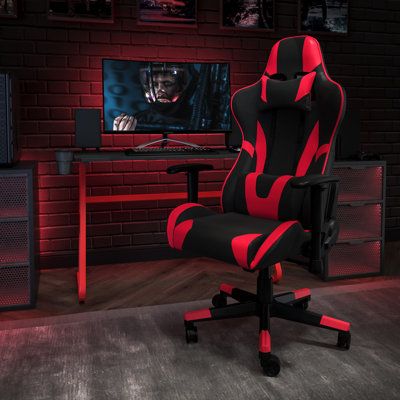 a gaming chair in front of a tv with the image of a demon on it