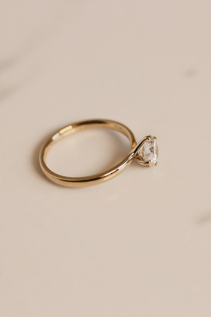 a gold ring with a single diamond on it