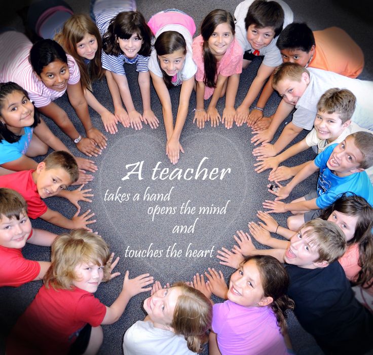 a group of children standing in a circle with their hands on the ground and saying at teacher