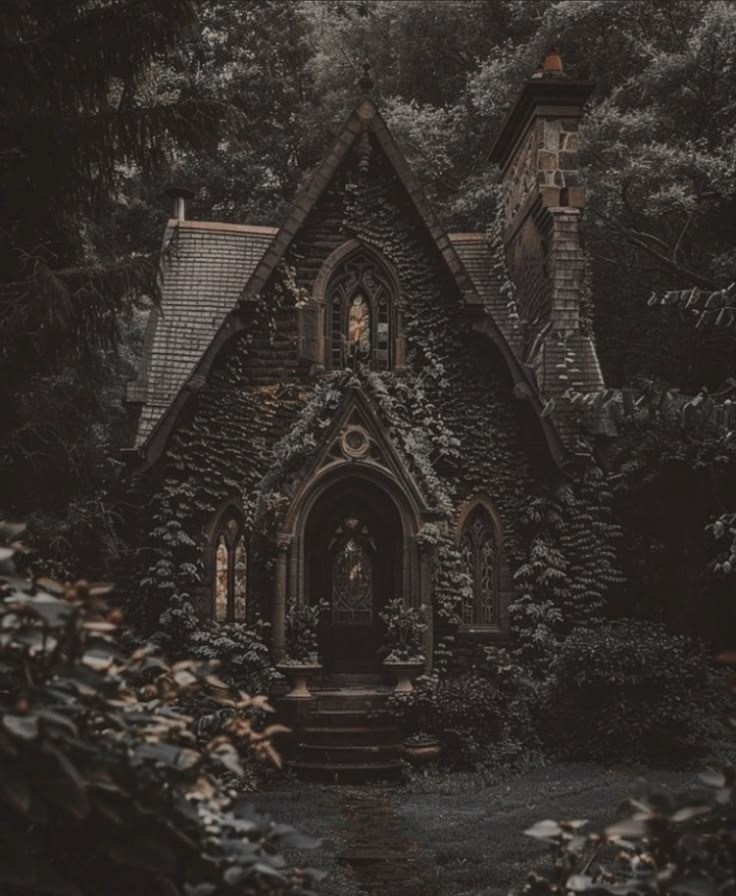 an old house with ivy growing all over it's walls and door, surrounded by trees