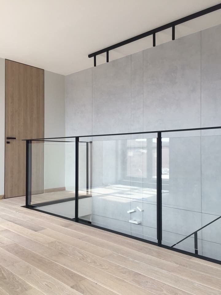 an empty room with wooden floors and glass walls on the wall is seen in this image