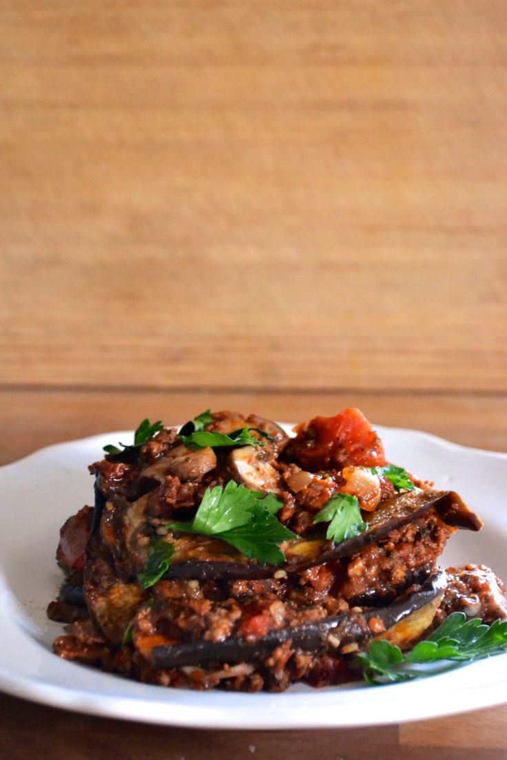 a white plate topped with food on top of a wooden table