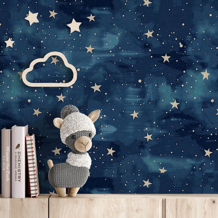 a stuffed animal sitting on top of a wooden shelf in front of a wall with stars