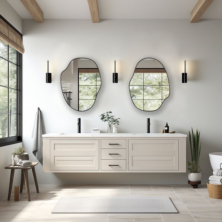 a bathroom with two sinks and three mirrors on the wall next to a bathtub