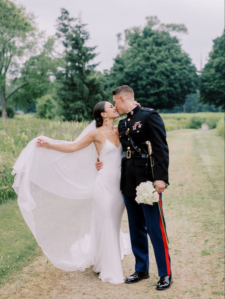 a bride and groom pose for a wedding photo