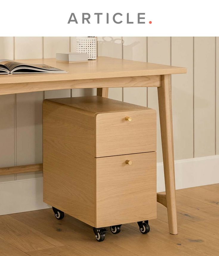 a wooden desk with a book on it and an open book sitting on top of it