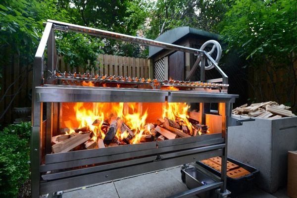 an outdoor fire pit with wood burning in it