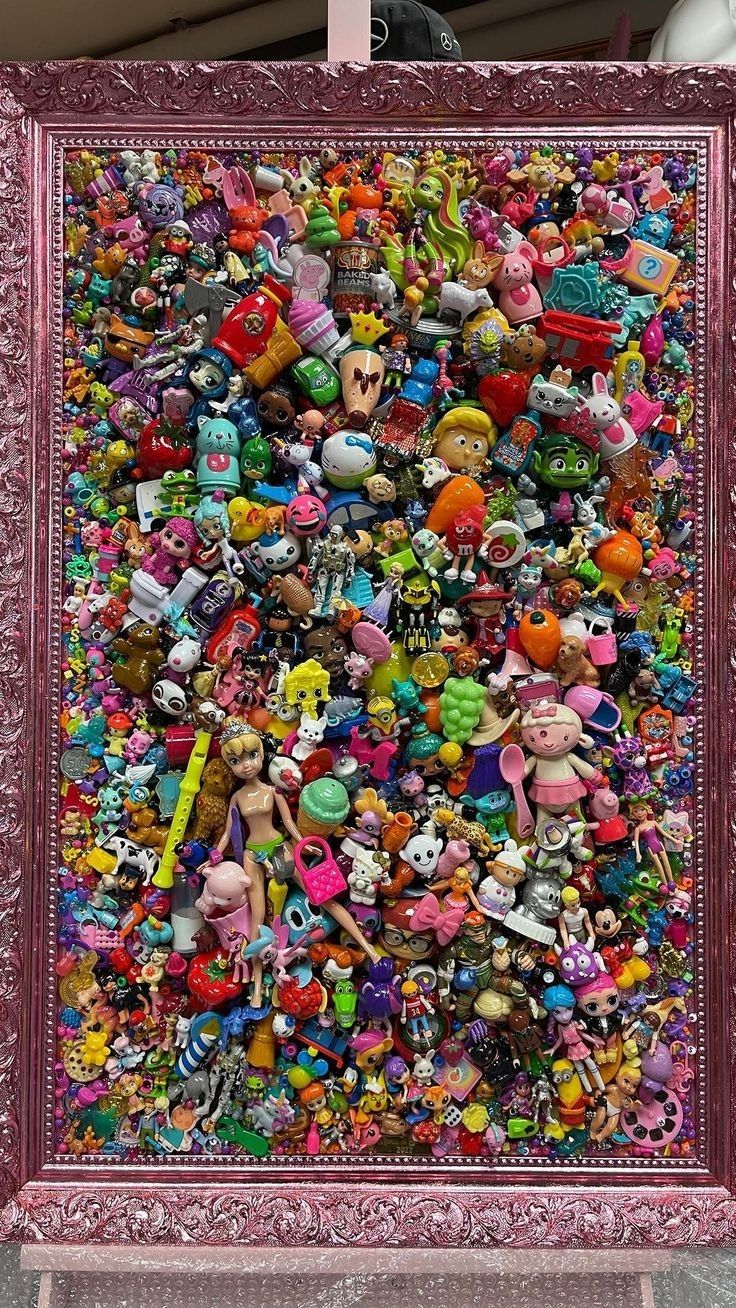 a large pile of stuffed animals in a pink frame