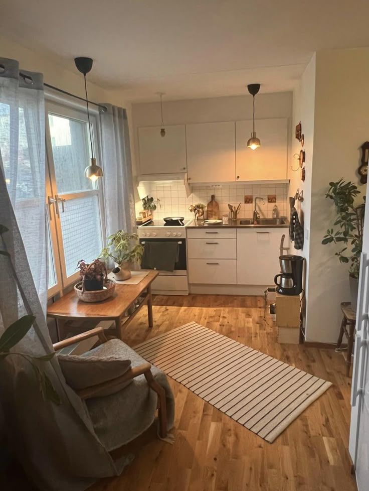 a living room and kitchen area with hardwood floors