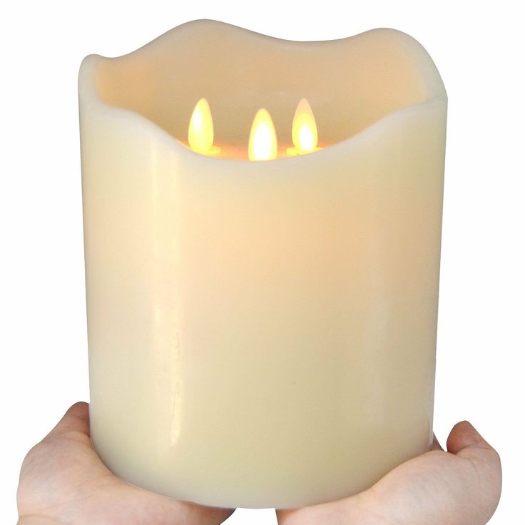 a person holding a lit candle in their hands