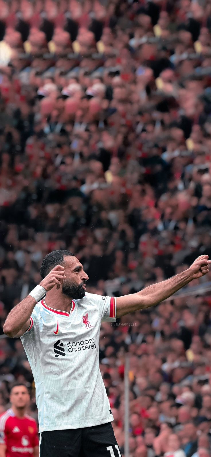 a soccer player is in the air with his arms outstretched