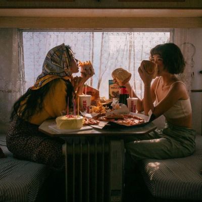 two women sitting at a table eating food