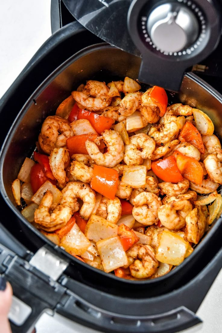 the food is being cooked in the slow cooker to make shrimp and carrots