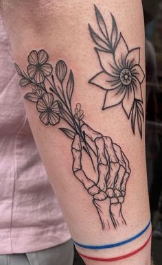 a person with a flower tattoo on their arm